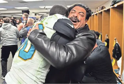  ??  ?? Owner Shad Khan and linebacker Telvin Smith celebrate the win that put the Jaguars in the AFC title game. RICK WILSON/AP