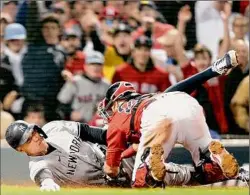  ?? Maddie Meyer / Getty Images ?? New York’s Aaron Judge, left, is tagged out by Boston’s Kevin Plawecki during the sixth inning on Tuesday night. Judge was mistakenly waved home before being easily thrown out.