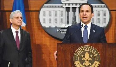  ?? AP PHOTO/TIMOTHY D. EASLEY ?? Louisville Mayor Craig Greenberg, right, speaks Wednesday during a news conference at Louisville Metro Hall in Louisville, Ky. U.S. Attorney General Merrick Garland, left, listens.