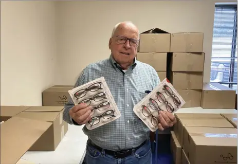  ?? PHOTOS BY BRYSON DURST — THE NEWS-HERALD ?? Prescripti­on Assistance Program of Ohio President Joel Lucia holds some of the 4,480pairs of reading glasses that the program is looking to give away.