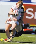  ?? CHRISTIAN K. LEE/ LAS VEGAS REVIEW-JOURNAL ?? American Alev Kelter, with Spain’s Maria Ribera holding on, scores a try during a USA Sevens rugby match Friday at Sam Boyd Stadium. The Americans won 22-7.