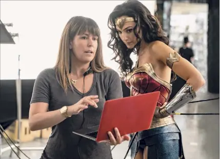  ?? Clay Enos / Associated Press ?? Director Patty Jenkins, left, with actress Gal Gadot on the set of “Wonder Woman 1984.”