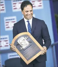  ?? Nathaniel Brooks/The New York Times ?? Former catcher Mike Piazza shows off his plaques during the Hall of Fame induction ceremony Sunday in Cooperstow­n, N.Y.