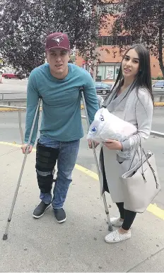  ??  ?? Paul Biegel of Dawson Creek, B.C. was one of four people hit Saturday night by a U-Haul truck fleeing police in downtown Edmonton. Biegel, shown with his girlfriend Tiana Clarke, says he feels lucky to be alive.
