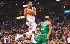  ?? USA TODAY Sports ?? Milwaukee Bucks forward Khris Middleton (22) drives for a shot over Boston Celtics forward Marcus Morris.