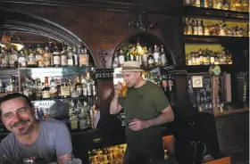  ?? Michael Short / Special to The Chronicle ?? Owner H. Joseph Ehrmann sips a beer behind the bar alongside manager Shea Shawnson at Elixir, S.F.’s second-oldest saloon, at 16th and Guerrero streets.