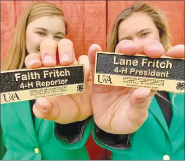  ?? (Courtesy Photo) ?? Sisters Faith (left) and Lane Fritch of Hiwasse pose on a country road near their home in the green jackets worn by 4-H state officers. Faith is the current 2020-2021 Arkansas 4-H state president. Her sister Lane was state president in 2017-2018.