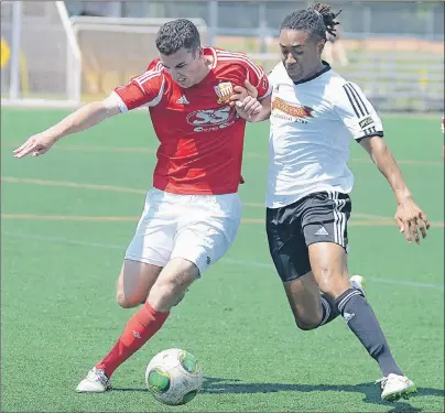  ?? JASON MALLOY/THE GUARDIAN ?? SoccerStop P.E.I. F.C.’s Noah Bitar, left, and Fredericto­n Reds midfielder Marcus Lees battle for the ball during McCain New Brunswick Premier Soccer League action Sunday at the Terry Fox Sports Complex in Cornwall.