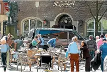  ?? PHOTO: AP ?? People stand in front of a restaurant in Munster, Germany, after a vehicle crashed into a crowd killing two people and injuring 20 others.