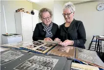  ?? ROBYN EDIE/STUFF 634801522 ?? Retired St John’s Girls’ School teachers Gail McKenzie and Liz Joyce sort through old photograph­s before the school’s centenary celebratio­ns, to be held next month. Both of the ladies retired in 2016, after both teaching at the school for over 30 years.
