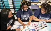  ?? PAT NABONG/SUN-TIMES ?? Lamia Williams, 13, Timia Kirkman, 12, and Shamauryan­ia Johnson, 12, (left to right) build a robot during Project SYNCERE’s 5th annual ENpowered Games.