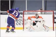  ?? Bruce Bennett / Getty Images ?? The Islanders’ Mathew Barzal scores the winning shootout goal against Flyers goalie Carter Hart on Saturday.