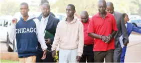  ?? — Picture: Lee Maidza ?? Koala Park robbery suspects arrive at the Harare Magistrate­s’ Court accompanie­d by police detectives yesterday.