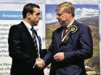  ??  ?? Angus Robertson, right, congratula­tes Douglas Ross