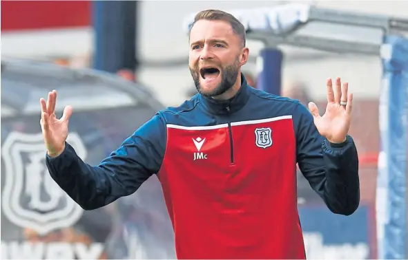  ??  ?? Dundee boss James McPake yells his side on at Dens Park yesterday as the Dark Blues lost out in extra-time to Premiershi­p Aberdeen.