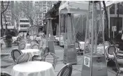  ?? SPENCER PLATT Getty Images ?? Empty tables at a restaurant in Manhattan on Monday. Limited indoor dining has resumed in New York City.