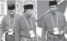  ?? - Bernama photo ?? Umno president Datuk Seri Dr Ahmad Zahid Hamidi (cenre) discussing something with deputy president Datuk Seri Mohamad Hasan (right) after a flag-raising ceremony at the party conference yesterday.Also present is Umno secretary-general Tan Sri Annuar Musa.