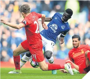  ??  ?? Reds’ Lucas Leiva tackles Idrissa Gueye of Everton.