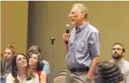  ?? GREG SORBER/JOURNAL ?? Ken Carpenter, an adjunct faculty member at UNM, asks President Garnett Stokes a question on the sports budget process during the town hall.