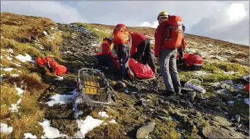  ??  ?? Members of Glen of Imaal Mountain Rescue respond to an injured walker.