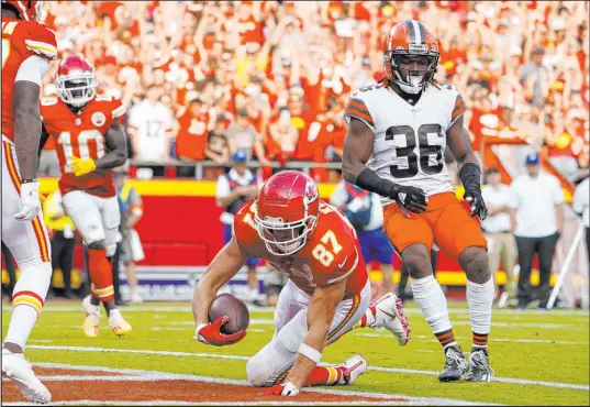  ?? Ed Zurga The Associated Press ?? Kansas City Chiefs tight end Travis Kelce scores a touchdown while Cleveland Browns safety M.J. Stewart Jr. watches on Sunday.