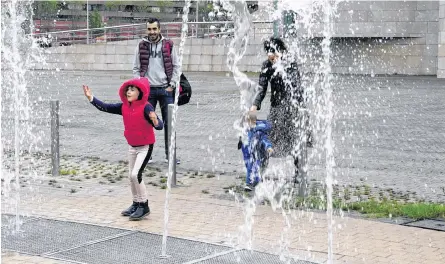  ?? REUTERS/VINCENT WEST ?? A girl plays in a fountain at the Guggenheim Museum, after restrictio­ns were partially lifted for children for the first time in six weeks, during the coronaviru­s disease (COVID-19) outbreak in Bilbao, Spain, Sunday.