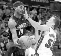  ?? LYNNE SLADKY/AP ?? Orlando guard Gary Harris, who finished with a game-high 20 points, passes the ball as Miami’s Duncan Robinson defends during the second half on Sunday.