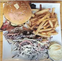  ?? ALANA HUDSON SPECIAL TO THE HAMILTON SPECTATOR ?? Coleslaw and fries accompanie­d the Twist bacon burger.