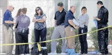  ?? Matt York Associated Press ?? LAW ENFORCEMEN­T officials gathered Thursday outside the Phoenix home where three boys were found dead in a closet. Their mother was hospitaliz­ed in critical condition with self-inflicted stab wounds, police said.