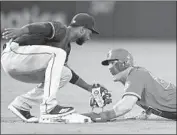  ?? John McCoy Getty Images ?? MIKE TROUT AVOIDS a tag by Texas’ Jurickson Profar in the sixth inning, getting a steal of second.