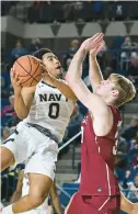  ?? DEBBIE LATTA/NAVY ATHLETICS ?? Navy point guard Austin Inge, left, goes up for a layup as Colgate forward Sam Thomson defends in Saturday’s game at Alumni Hall.