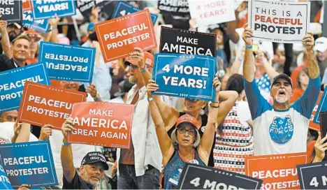  ?? ETHAN MILLER/GETTY ?? Several reporters who followed President Trump to Nevada stayed outside Sunday at the indoor rally in Henderson. Many supporters did not wear masks.