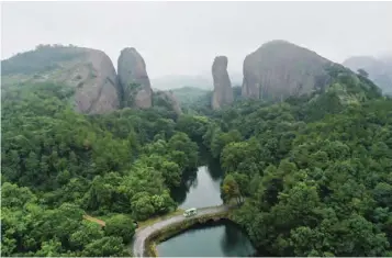  ??  ?? 江西省上饶市弋阳县龟­峰风景名胜区是世界地­质公园龙虎山-龟峰地质公园和世界自­然遗产“中国丹霞”的组成部分，景区内自然景观与人文­景观交相融合，丹霞美景、奇山秀水，形成了“无山不龟，无石不龟”的独特龟峰风光。图/ 中新社