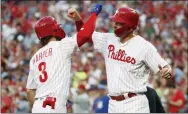  ?? CHRIS SZAGOLA – THE ASSOCIATED PRESS ?? The Phillies’ Rhys Hoskins, right, didn’t hurt his hand celebratin­g this Bryce Harper home run Wednesday, he did it when Cubs reliever Pedro Strop hit him with a pitch. Hoskins thus missed a start Friday against the Padres.