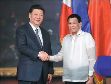  ?? FENG YONGBIN / CHINA DAILY ?? President Xi Jinping meets Philippine President Rodrigo Duterte in Manila on Tuesday. Xi arrived in the country’s capital earlier in the day, and Duterte hosted a grand ceremony to welcome Xi before their talks.