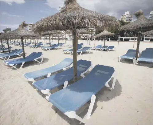  ??  ?? EMPTY: sun loungers on a beach in Spain. Photo: Getty images