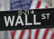  ?? SETH WENIG — THE ASSOCIATED PRESS ?? This photo shows a Wall Street sign near the New York Stock Exchange in New York. Stock markets turned lower in European trading on Thursday as a rebound in oil prices ran out of steam.