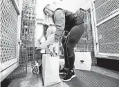  ?? CHARLIE NEIBERGALL/AP ?? A volunteer packs food at the Des Moines Area Religious Council food pantry Tuesday in Des Moines, Iowa.