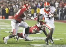  ?? Curtis Compton / Associated Press ?? Georgia running back Sony Michel runs for a touchdown during the second overtime to win it for the Bulldogs.