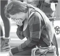  ?? MARCIO JOSE SANCHEZ, AP ?? A woman cries Sunday at the scene of the Oakland warehouse fire. Officials continue to search the charred rubble from the fatal fire.