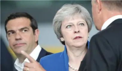  ?? © epaefe ?? Theresa May en haar Griekse collega Alexis Tsipras (links) deze zomer op een Navotop in Brussel.