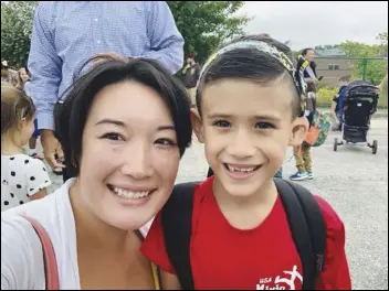  ?? Associated Press ?? Nancy Glynn of Manchester, N.H., with her son Hunter, is on the losing side of a growing movement to provide U.S. workers with paid parental leave. Congress passed a bill earlier in the week giving the country’s 2.1 million government employees 12 weeks of paid parental leave as part of a defense bill that President Donald Trump signed into law Friday.