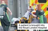  ??  ?? A patient is brought into the Royal London Hospital