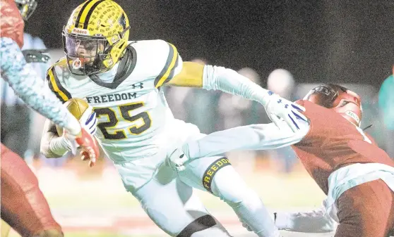  ?? DAVID GARRETT/SPECIAL TO THE MORNING CALL ?? Freedom’s Deante Crawford (25) is tackled by St. Joe’s Prep’s Omillio Agard Friday night in a PIAA Class 6A quarterfin­al-round football game at Cardinal O’Hara High School in Springfiel­d, Pa.