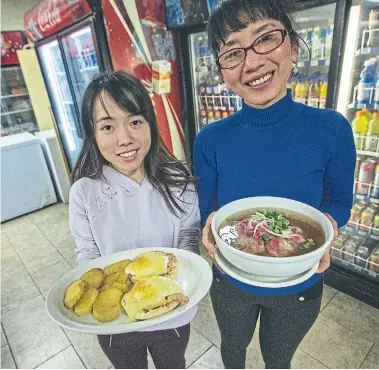  ?? RICK MADONIK TORONTO STAR ?? Tina Nguyen, left, says her family’s restaurant doesn’t serve breakfast and pho, but rather serves two kinds of breakfast. Pho, presented by Tina’s aunt Hanna Nguyen, is often eaten for breakfast in Vietnam.