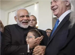  ?? AP ?? Indian Prime Minister Narendra Modi, left, with Israeli Prime Minister Benjamin Netanyahu meet with with Moshe Holtzberg at the King David Hotel in Occupied Jerusalem, on Wednesday. —