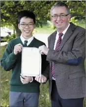  ??  ?? Oscar Yeoh with principal John Murphy.