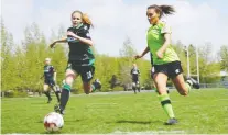  ?? ALYSSA BALLAN ?? Damiane Sawatzky, left, of Calgary Foothills and Taneil Gay of QC United vie for a loose ball during United Women’s Soccer action Sunday at Regina Rugby Park.