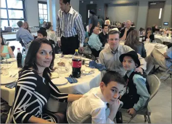  ?? Courtesy photo ?? A family celebrates during a Seder event held at Temple Beth Ami in Santa Clarita.