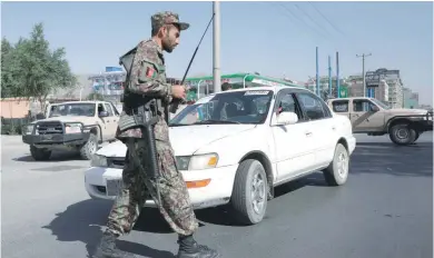  ?? — Reuters ?? An Afghan National Army (ANA) soldier stands at a check point in Kabul.